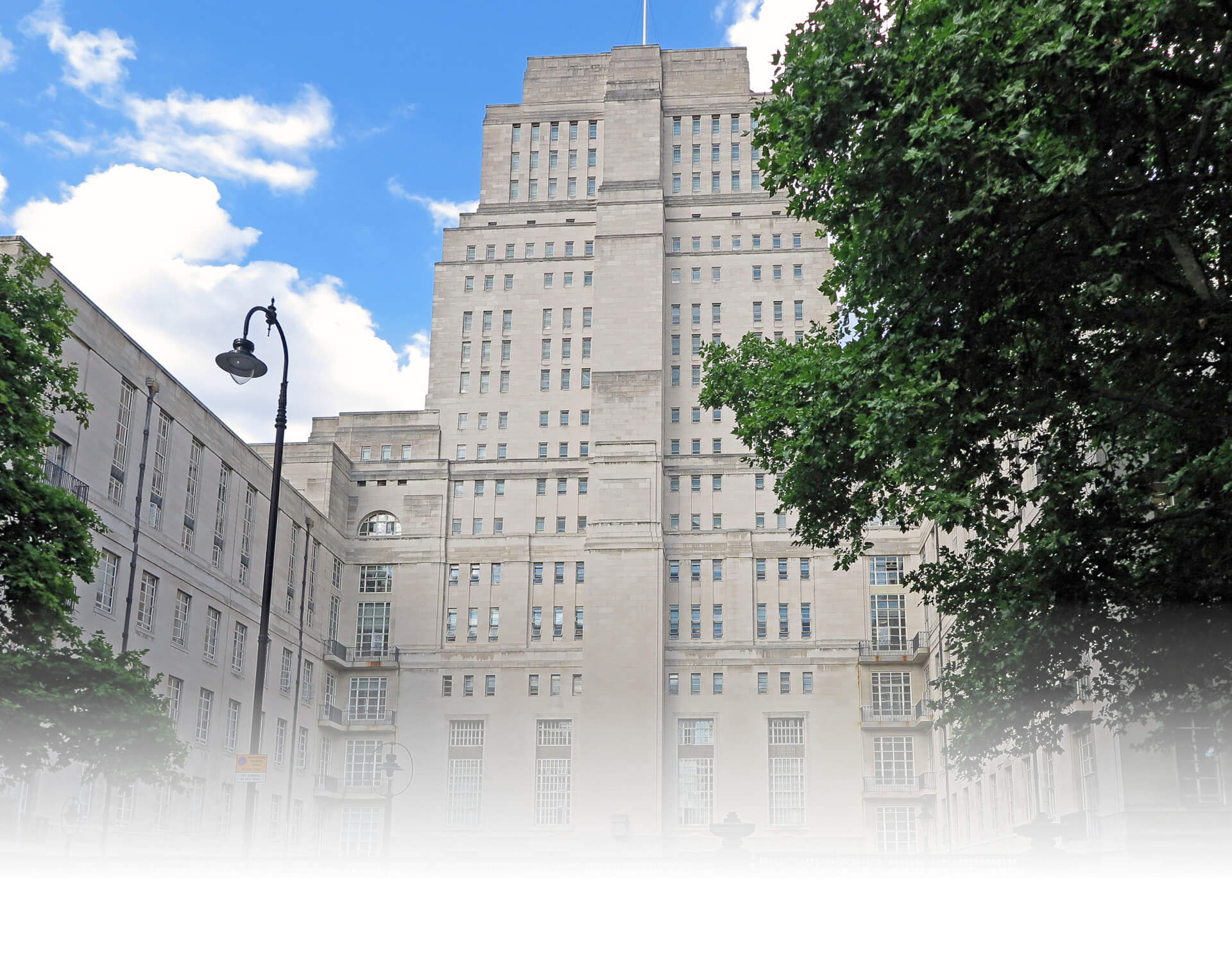 Photograph of Senate House building in London UK taken from Malet Street. This is a multi-story building and shows a tree and lamppost in the foreground.